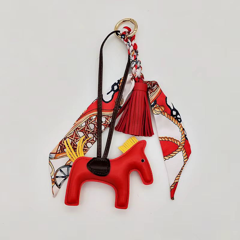 PONY BAG CHARM WITH SCARF AND TASSEL