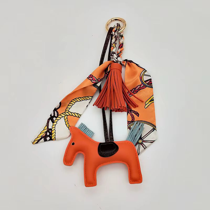 PONY BAG CHARM WITH SCARF AND TASSEL